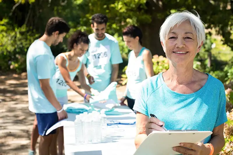 coach-smiling-while-athletes-registering